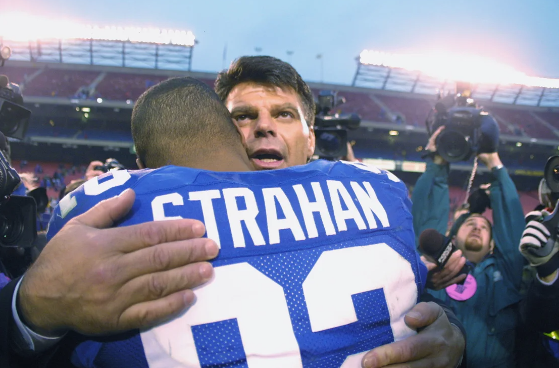 Gastineau congratulates Strahan after breaking the single-season sack record.